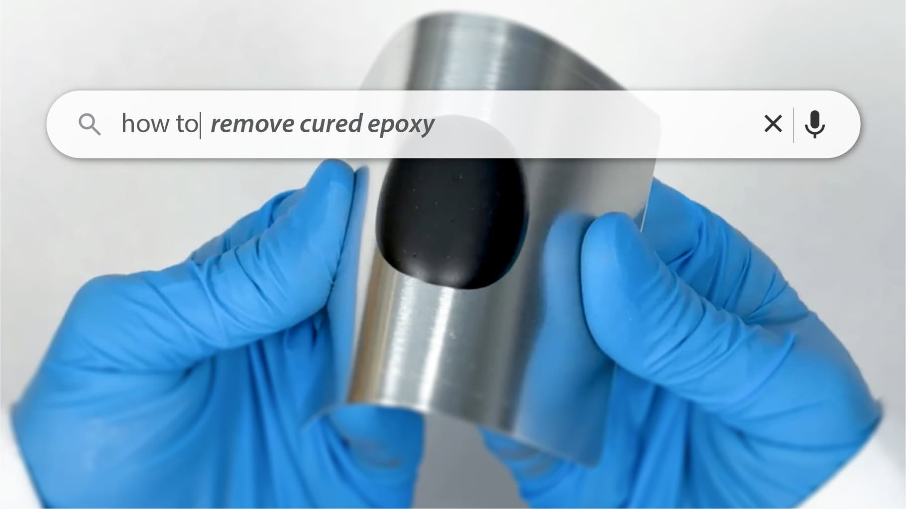 Gloved hands holding a curved piece of metal with a black patch of cured epoxy; a search bar overlay reads &lsquo;how to remove cured epoxy.&rsquo;